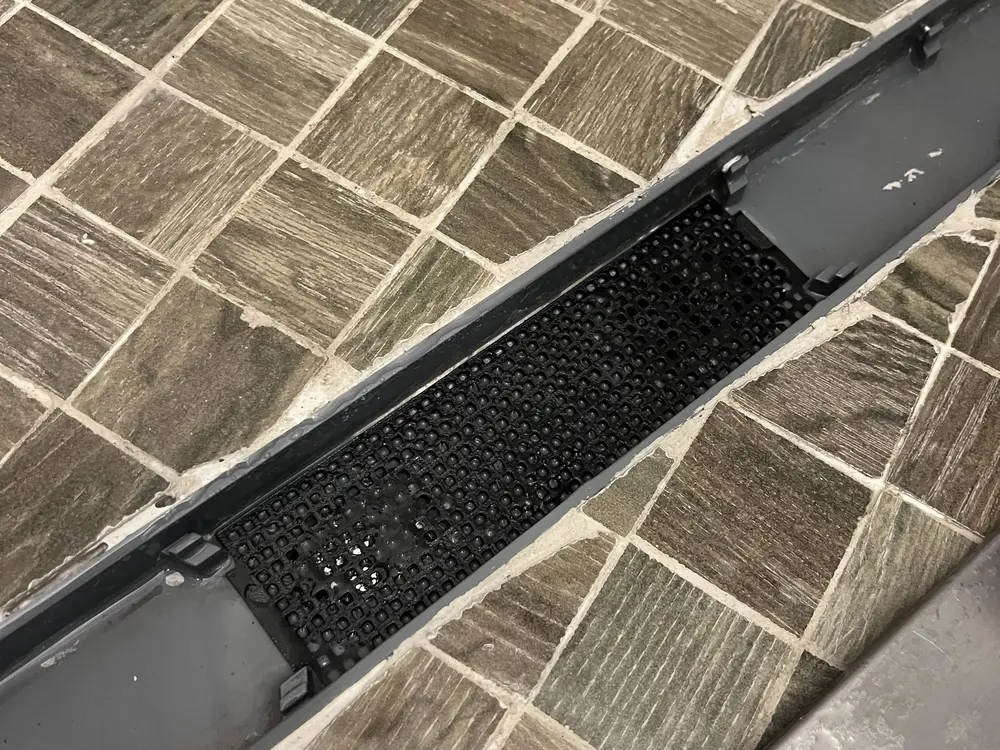 Shower drain grate
