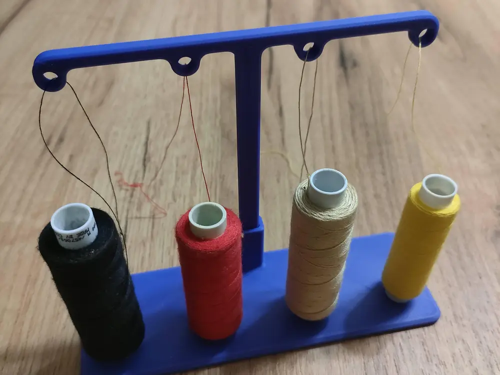 Thread guide for sewing machine for four spools
