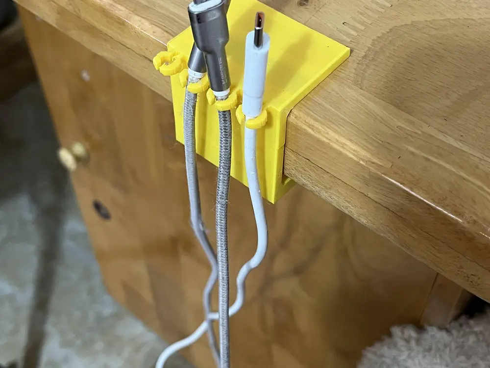 desk-edge charging cable holder