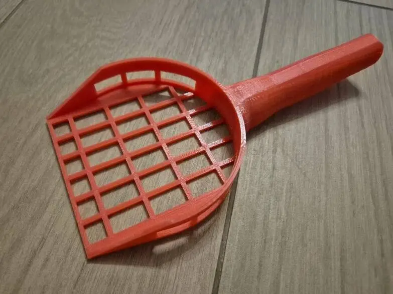Cucharilla para arena de gato con rejilla