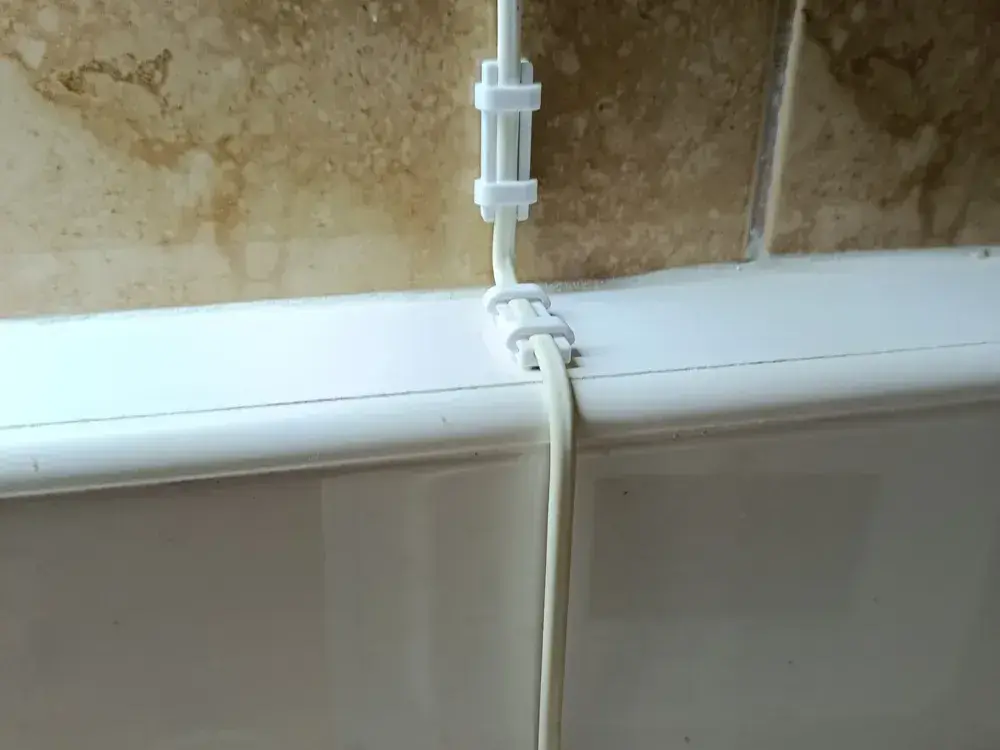 Self-adhesive cable clip